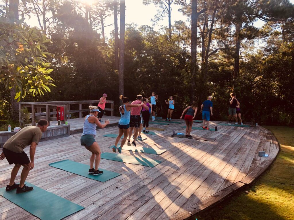 People on mats outside doing exercises