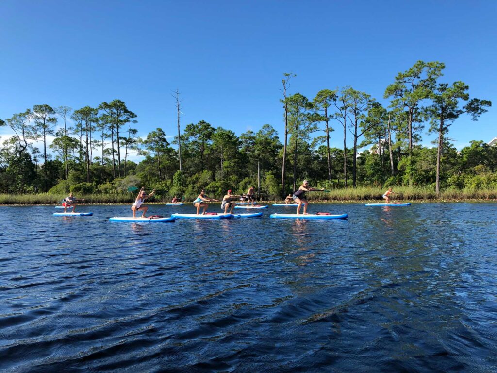 Group doing excerises on paddle boards during class
